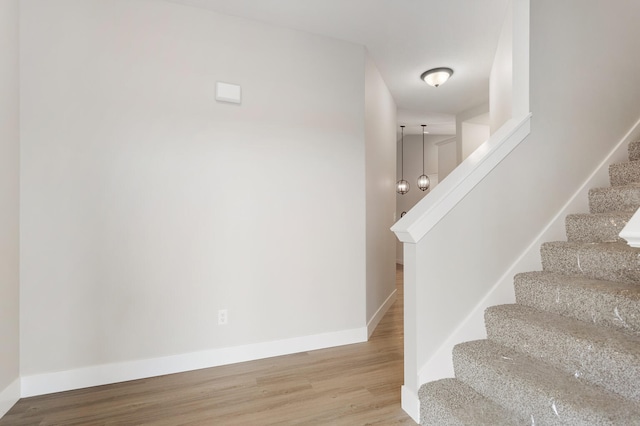 stairway featuring wood-type flooring