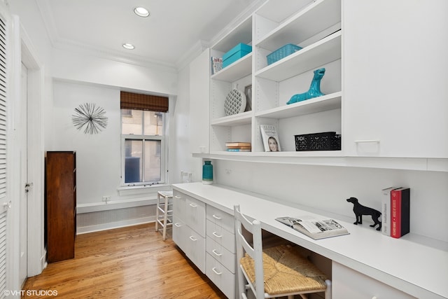 office space featuring crown molding and light hardwood / wood-style flooring