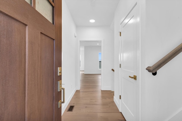 hall with light hardwood / wood-style flooring