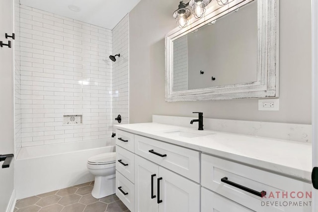 full bathroom with tiled shower / bath combo, toilet, tile flooring, and vanity