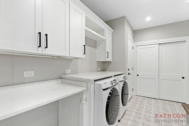 laundry room featuring cabinets, separate washer and dryer, and light tile flooring