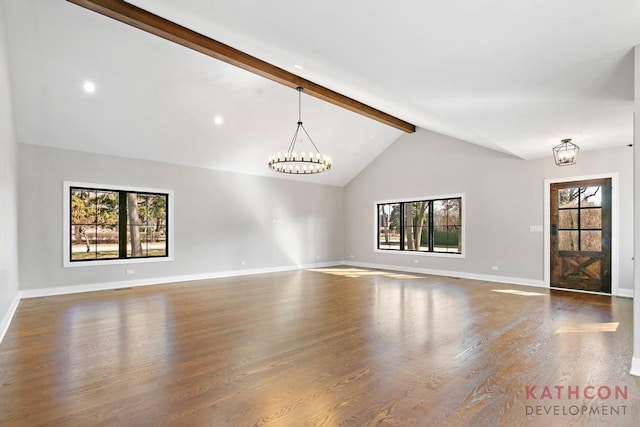 unfurnished living room featuring lofted ceiling with beams, dark hardwood / wood-style flooring, and an inviting chandelier