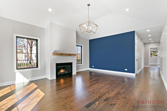 unfurnished living room featuring dark hardwood / wood-style flooring and a healthy amount of sunlight