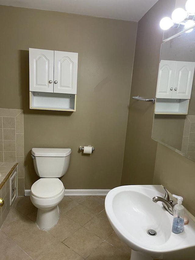 bathroom featuring tile patterned flooring, sink, and toilet