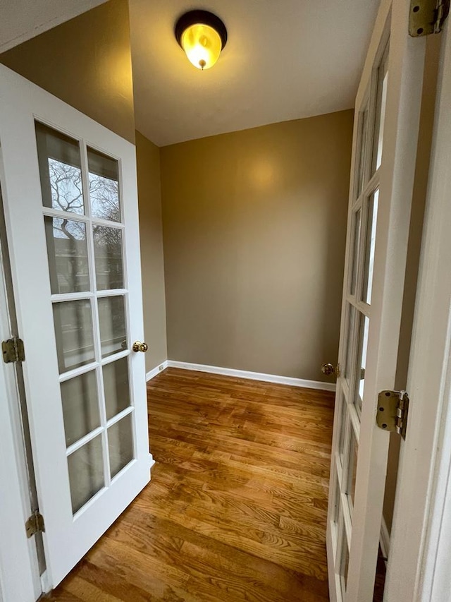 unfurnished room with hardwood / wood-style flooring and french doors