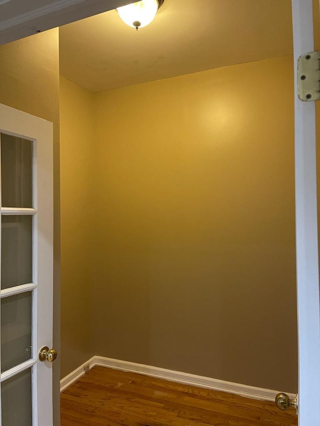 spare room featuring wood-type flooring