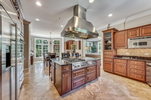 kitchen featuring appliances with stainless steel finishes, dark stone counters, light tile floors, and island range hood