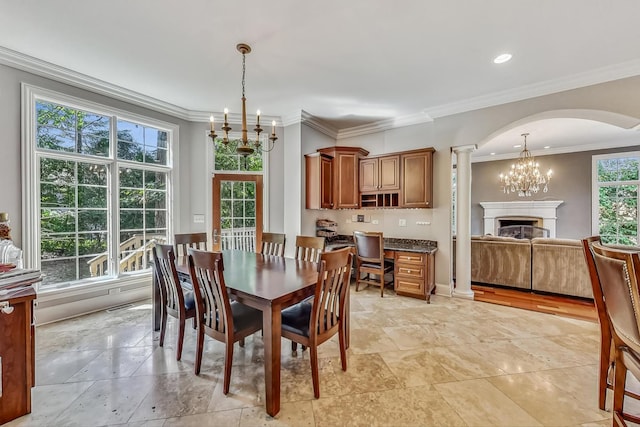 dining area featuring a healthy amount of sunlight, ornamental molding, and light tile floors