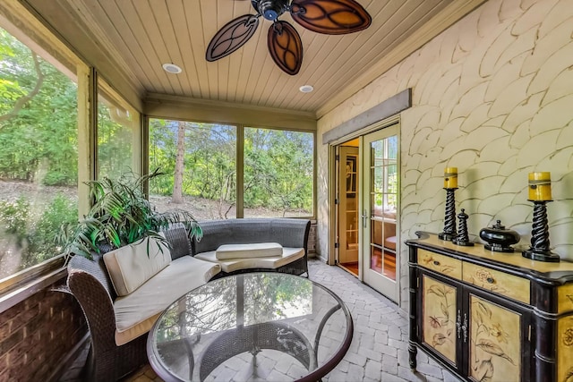 sunroom / solarium with plenty of natural light, ceiling fan, french doors, and wood ceiling