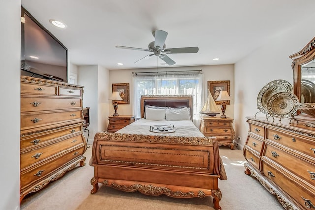 bedroom featuring light colored carpet and ceiling fan