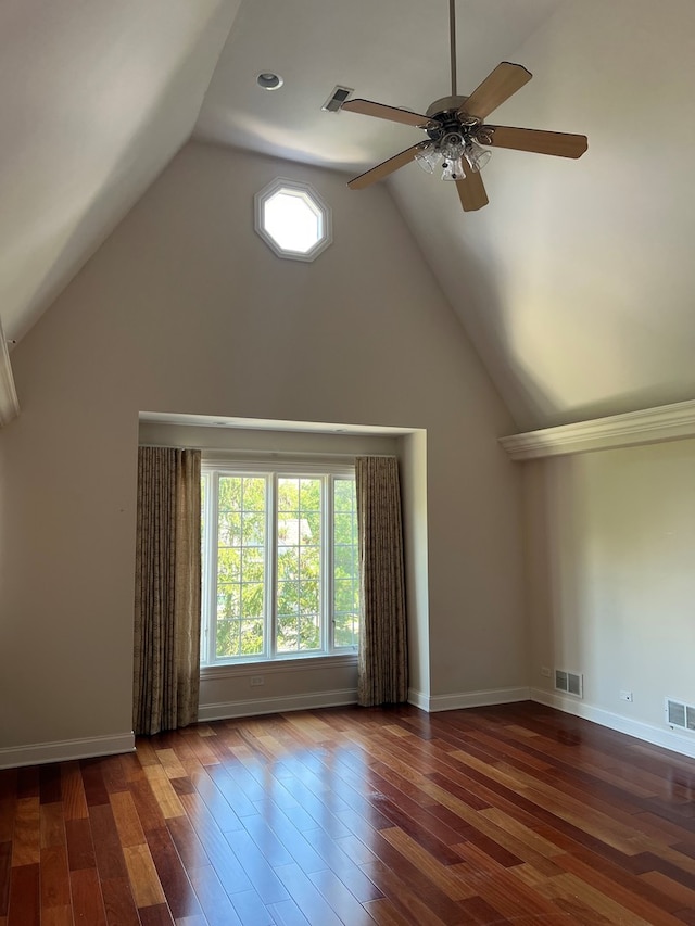 interior space featuring dark wood-type flooring, ceiling fan, and vaulted ceiling