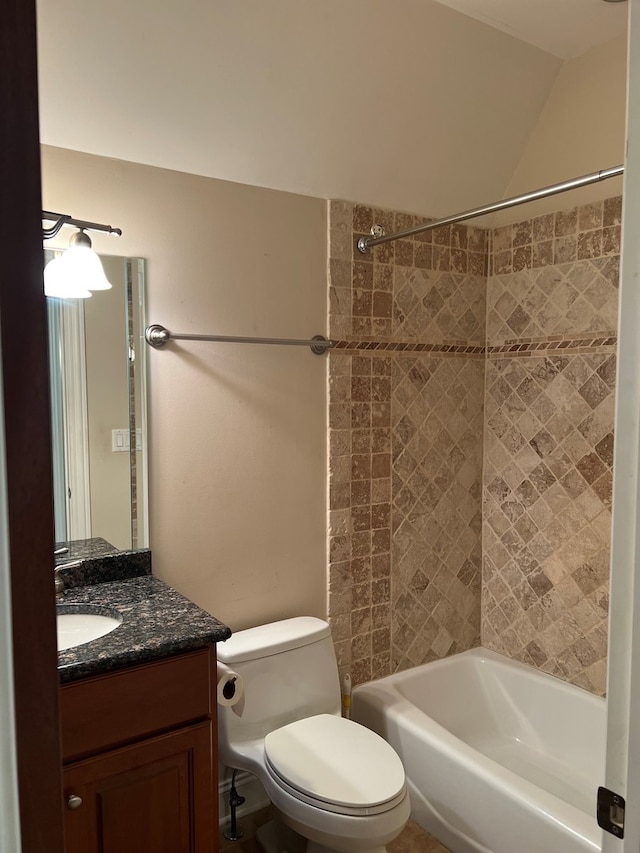 full bathroom with tiled shower / bath, toilet, and vanity