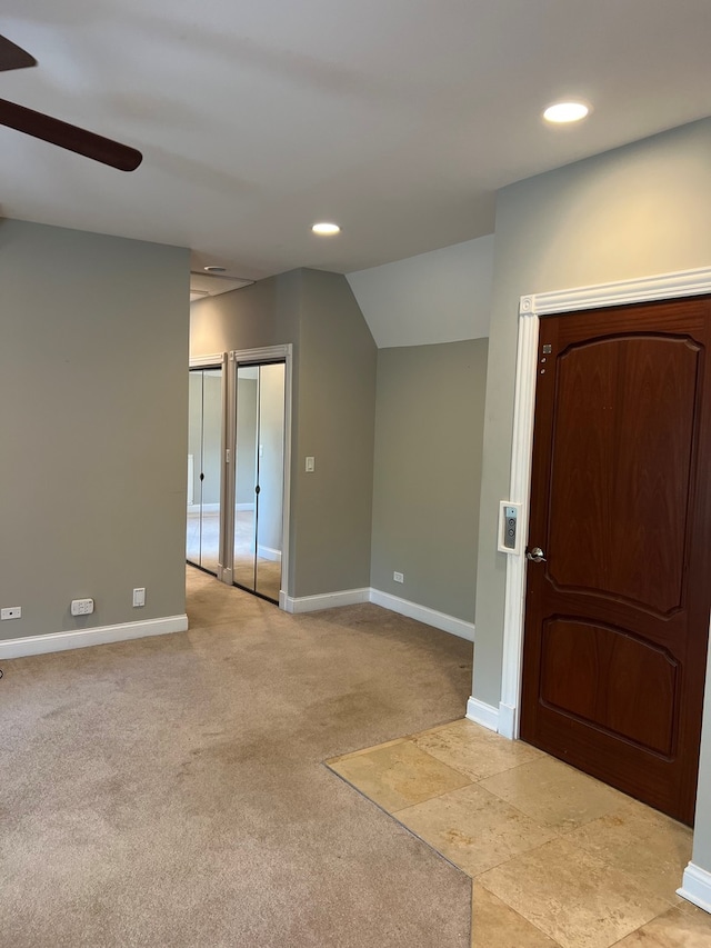 interior space with ceiling fan and vaulted ceiling