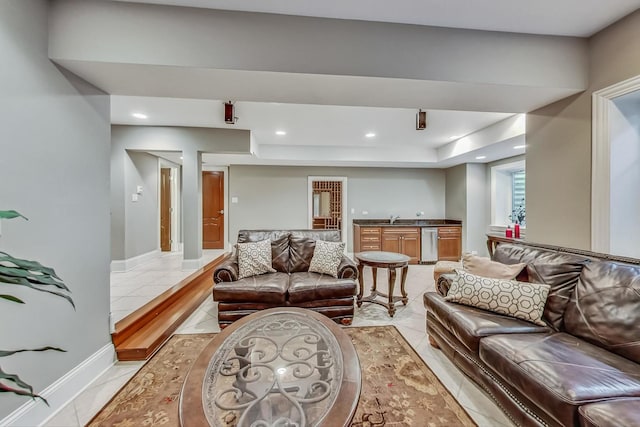 tiled living room featuring sink