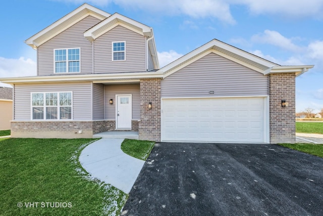 view of front of property with a garage, driveway, a front yard, and brick siding