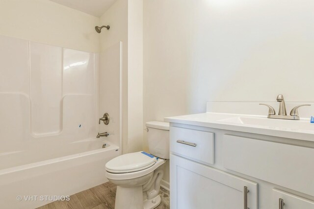 full bathroom featuring bathing tub / shower combination, toilet, and vanity