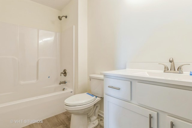 full bath with wood finished floors, bathing tub / shower combination, vanity, and toilet