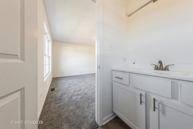 bathroom featuring vanity, visible vents, and baseboards