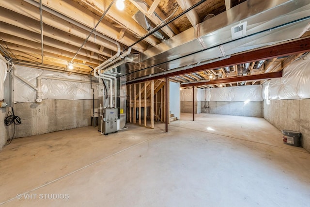 unfinished basement featuring heating unit