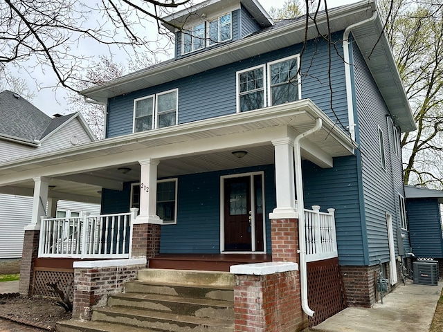 craftsman inspired home featuring covered porch and central AC unit