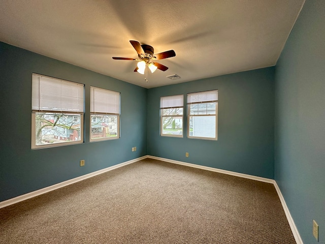 spare room featuring carpet and ceiling fan