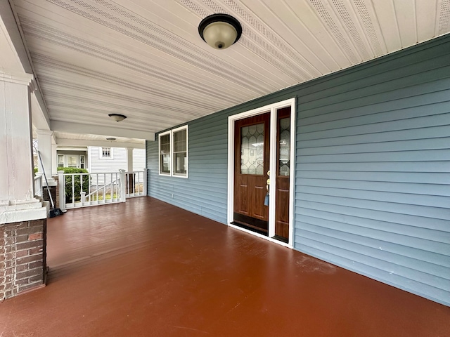 view of exterior entry featuring a porch