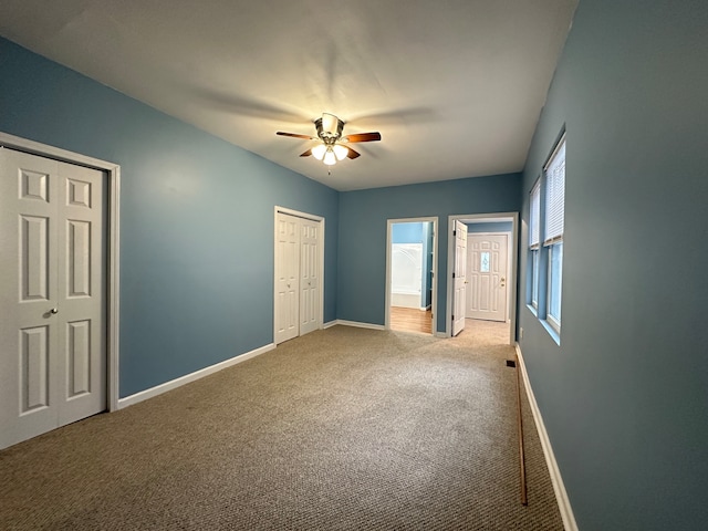 carpeted empty room featuring ceiling fan