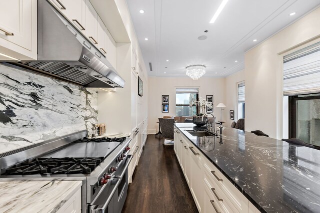 159 E Walton Pl Unit Ph, Chicago, IL 60611 - kitchen featuring range with two ovens, under cabinet range hood, a sink, dark wood-style floors, and dark stone countertops