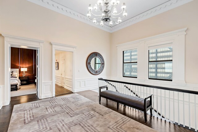 159 E Walton Pl Unit Ph, Chicago, IL 60611 - entryway featuring a chandelier, a decorative wall, wainscoting, and dark wood-type flooring