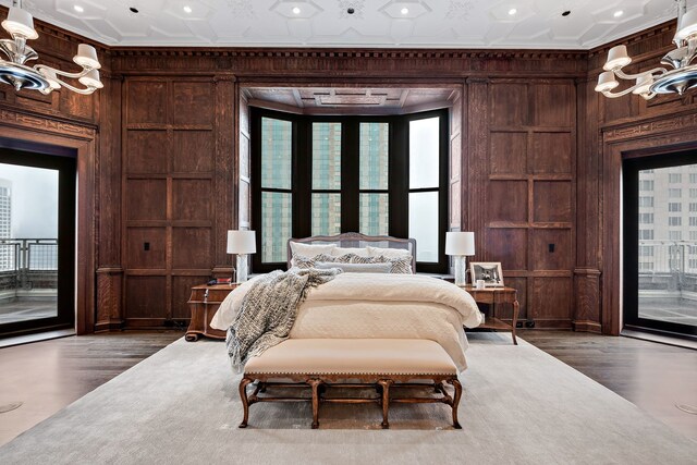 159 E Walton Pl Unit Ph, Chicago, IL 60611 - bedroom featuring access to exterior, wooden walls, multiple windows, wood finished floors, and crown molding