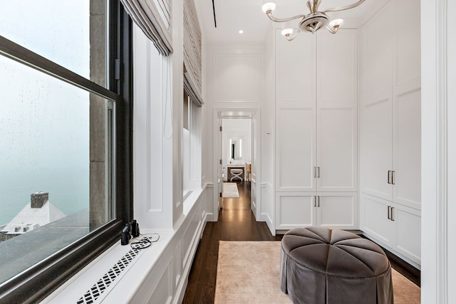 159 E Walton Pl Unit Ph, Chicago, IL 60611 - hall with a decorative wall, dark wood-style floors, and a chandelier