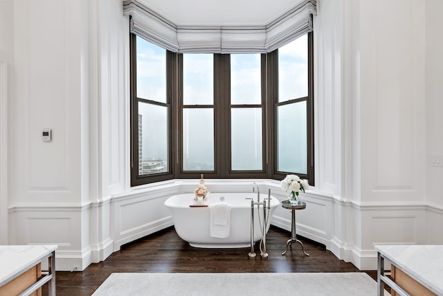159 E Walton Pl Unit Ph, Chicago, IL 60611 - bathroom with a decorative wall, a freestanding bath, wood finished floors, and vanity