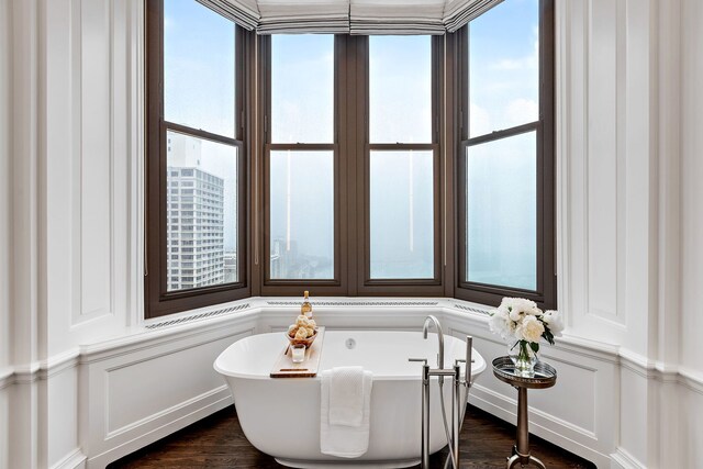 159 E Walton Pl Unit Ph, Chicago, IL 60611 - full bathroom with a decorative wall, a soaking tub, plenty of natural light, and wood finished floors