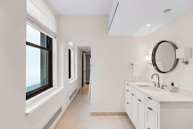 159 E Walton Pl Unit Ph, Chicago, IL 60611 - bathroom featuring healthy amount of natural light, vanity, baseboards, and recessed lighting