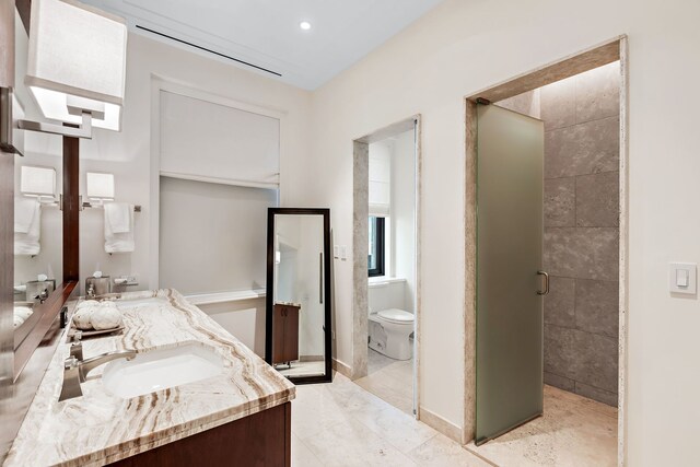 159 E Walton Pl Unit Ph, Chicago, IL 60611 - full bath with double vanity, a shower stall, and toilet