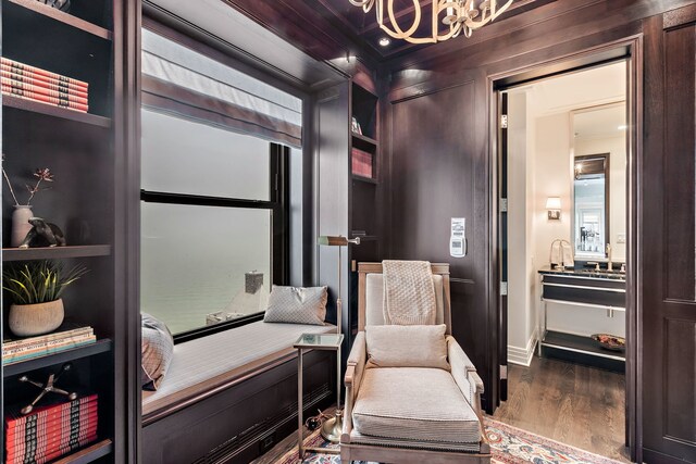 159 E Walton Pl Unit Ph, Chicago, IL 60611 - sitting room with wood finished floors, a chandelier, and crown molding