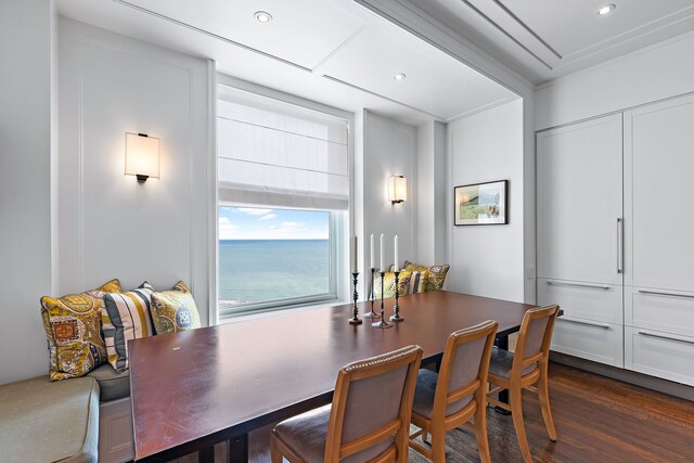 dining area featuring ornamental molding, dark wood finished floors, and recessed lighting