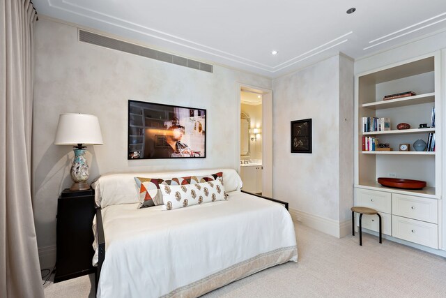 bedroom featuring light carpet, connected bathroom, visible vents, and baseboards