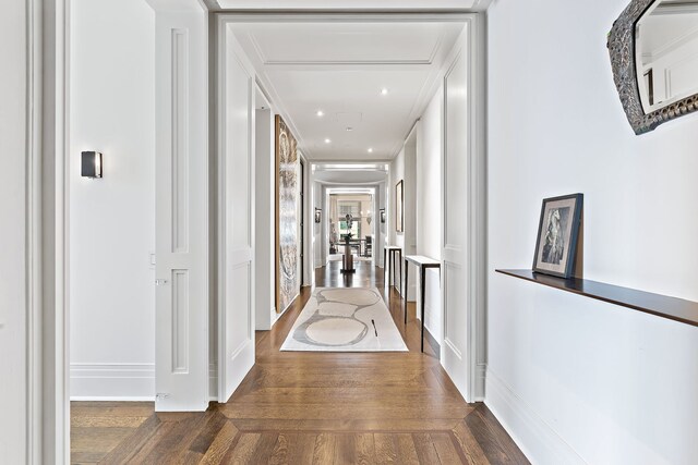 corridor featuring dark wood-type flooring, recessed lighting, and baseboards