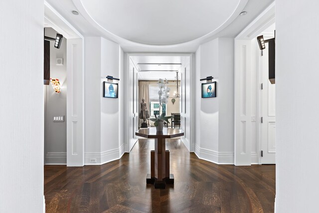 hall with wood finished floors and baseboards