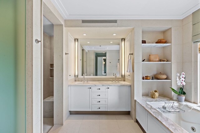 bathroom with crown molding, a sink, visible vents, and tile patterned floors