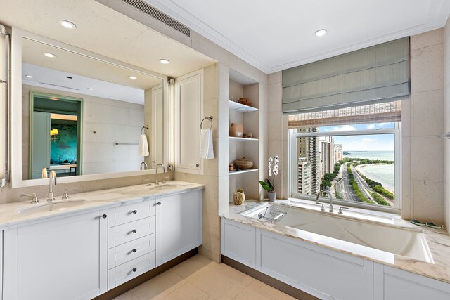 bathroom featuring a tub to relax in, crown molding, visible vents, and a sink