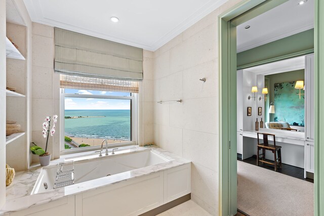 bathroom with a bathing tub, tile walls, crown molding, and recessed lighting