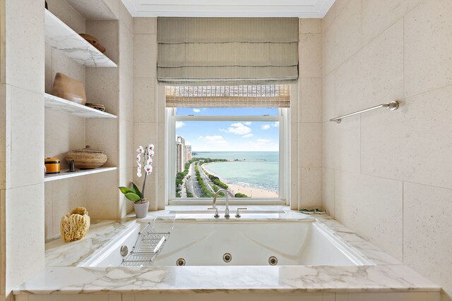 bathroom with a water view and a jetted tub