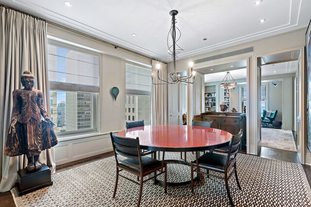 dining area featuring recessed lighting, a notable chandelier, and wood finished floors