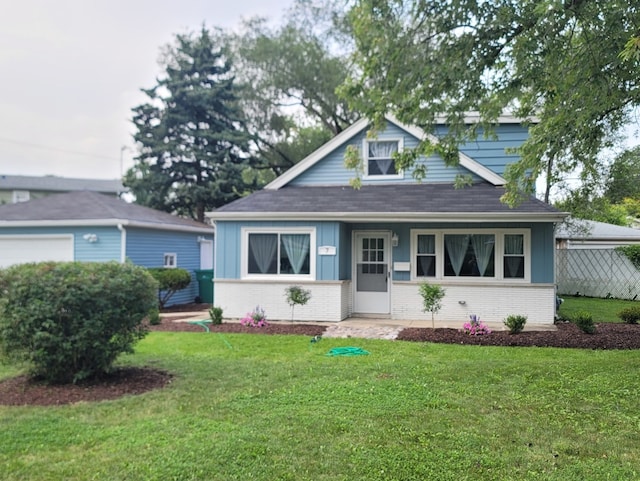 bungalow-style home with a front lawn