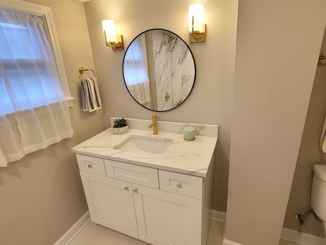 bathroom featuring tile patterned floors, vanity, and toilet