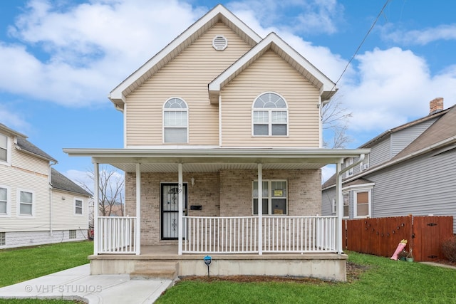 front of property featuring covered porch and a front yard