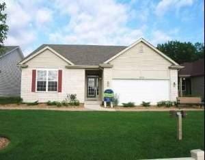 single story home featuring a garage and a front lawn