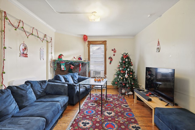 living room featuring crown molding, cooling unit, and wood-type flooring